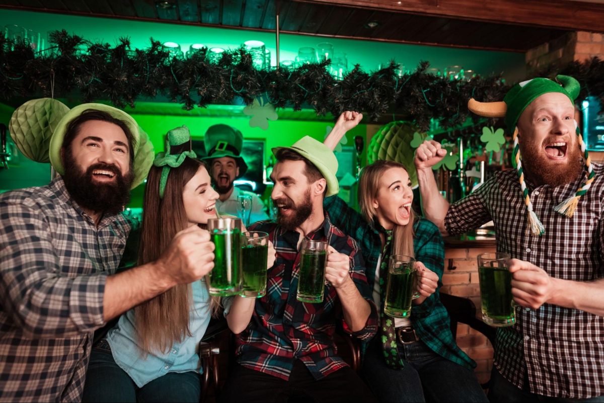 Friends celebrating St. Patrick's Day at bar